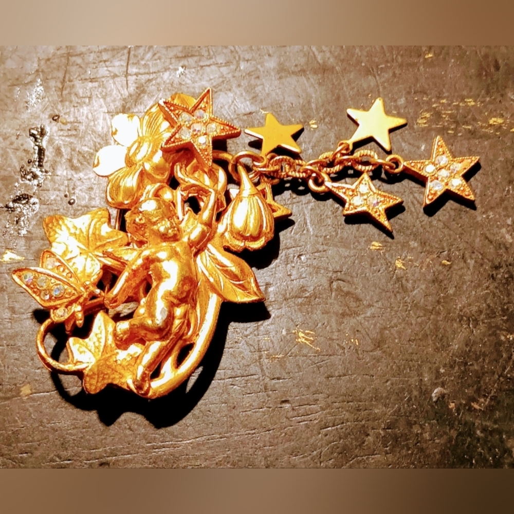 Kirk Folly Gold tone Angel with flower brooch.